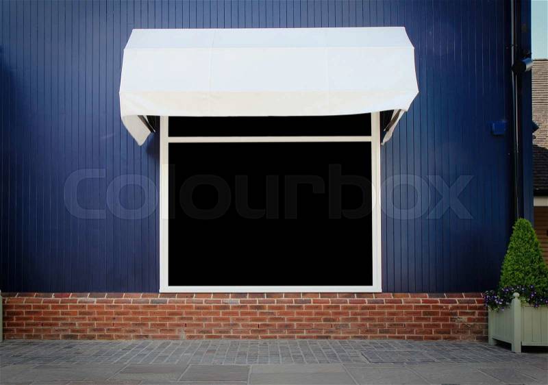 Shopfront vintage store front with canvas awnings and blank display, stock photo