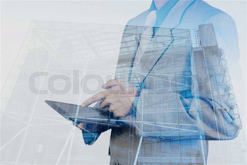 Double exposure of success businessman using digital tablet with abstract building , stock photo
