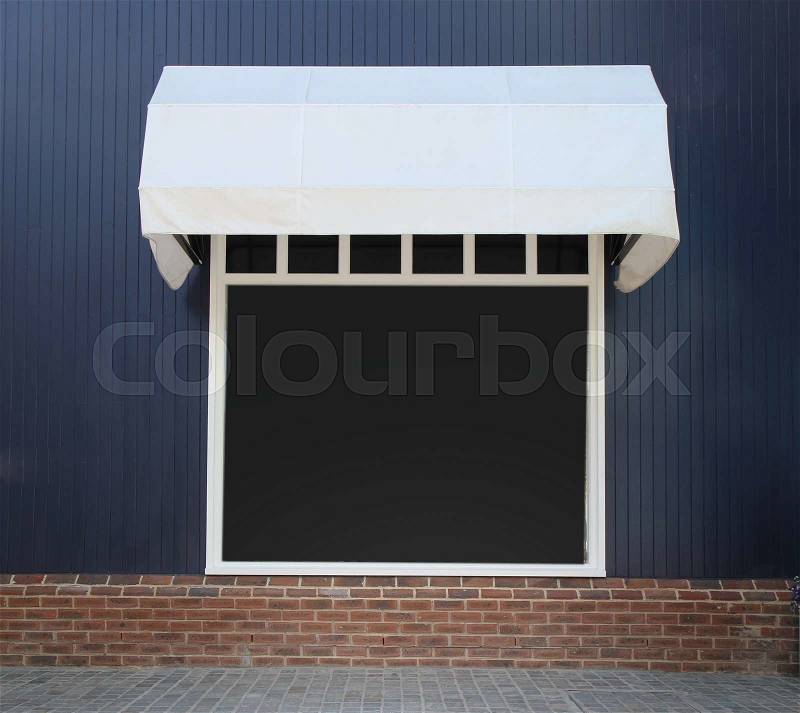 Shopfront vintage store front with canvas awnings and blank display , stock photo