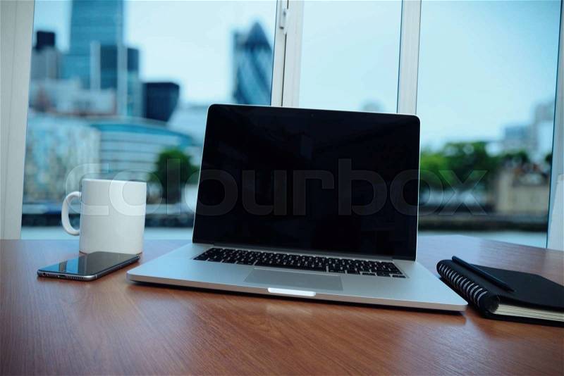 Business documents on office table with smart phone and digital tablet as work space business and london city blurred background, stock photo