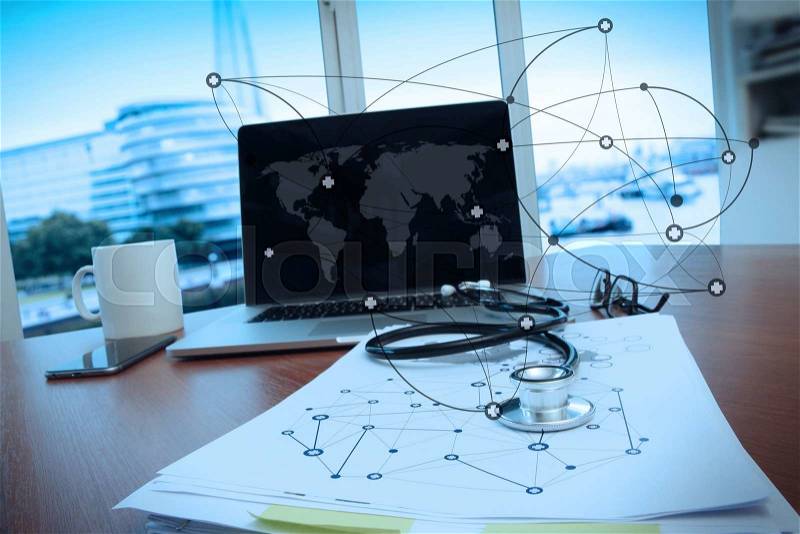 Doctor workspace with laptop computer in medical workspace office and medical network media diagram as concept, stock photo