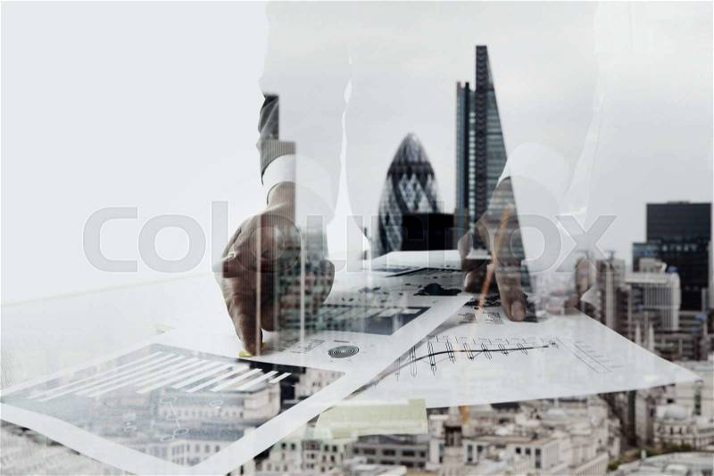 Double exposure of businessman working with new modern computer and london city blurred background, stock photo