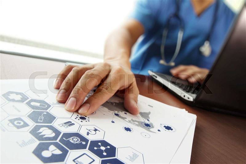 Doctor working with laptop computer in medical workspace office and medical network media diagram as concept, stock photo