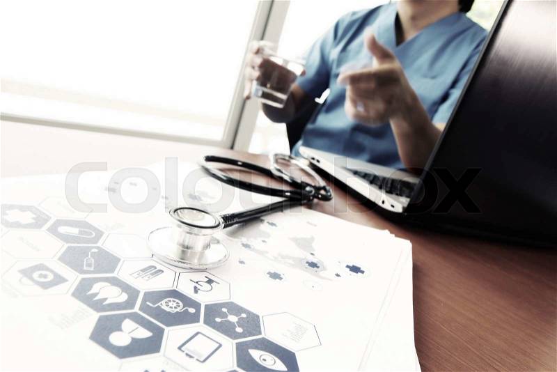 Doctor working with laptop computer in medical workspace office and medical network media diagram as concept, stock photo