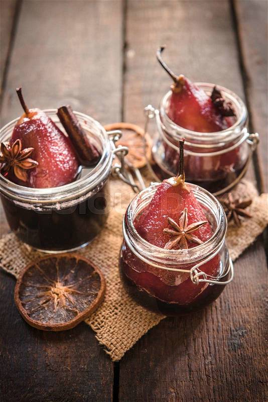 Pears cooked in the red wine served in jars,selective focus , stock photo