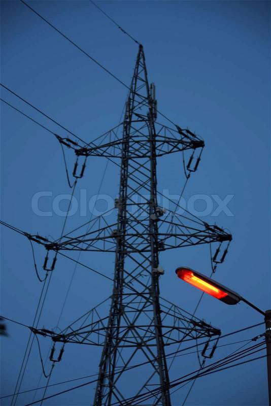 An electrical pylon against a blue sky, stock photo