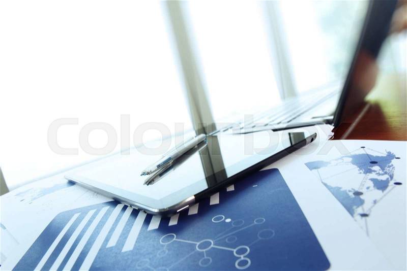 Business documents on office table with smart phone and digital tablet as work space business concept, stock photo