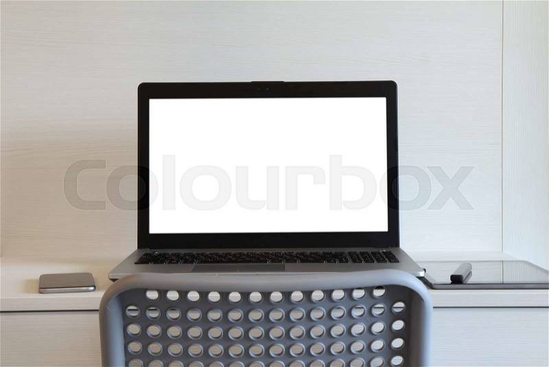 Blank screen laptop computer with table lamp is on twooden desk as workplace concept, stock photo