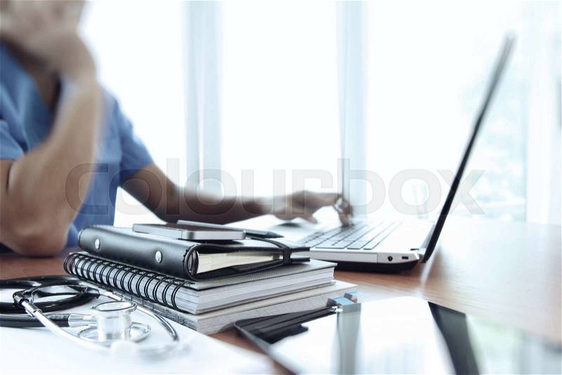 Doctor working with laptop computer in medical workspace office as concept, stock photo