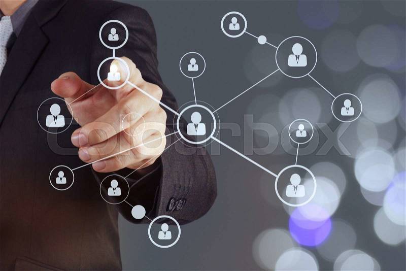 Businessman hand showing human icon flow chart on new modern computer as concept with bokeh exposure, stock photo
