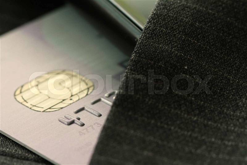Credit cards in very shallow focus with gray suit background, stock photo