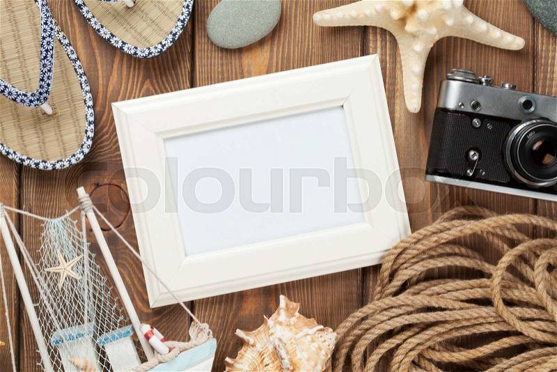 Travel and vacation photo frame and items on wooden table. Top view, stock photo