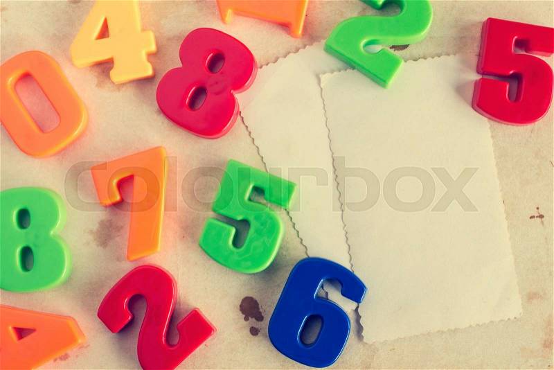 Colorful plastic numbers with empty cards for your text. Vintage image, stock photo