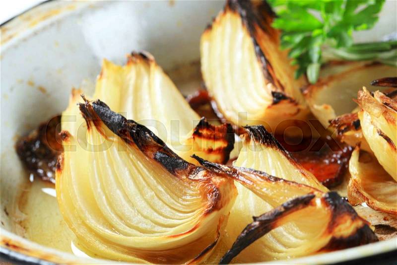 Pan roasted onion wedges on a frying pan, stock photo