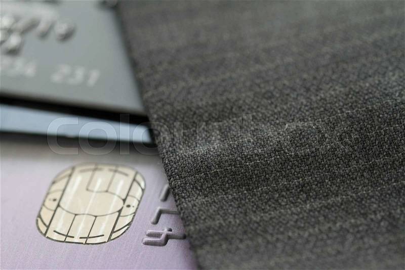 Credit cards in very shallow focus with gray suit background, stock photo