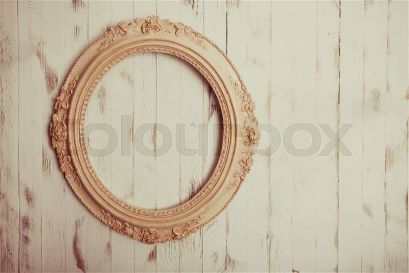 Oval vintage frame on a wooden background, stock photo