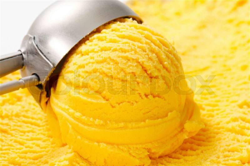 Scoop of yellow ice cream, stock photo