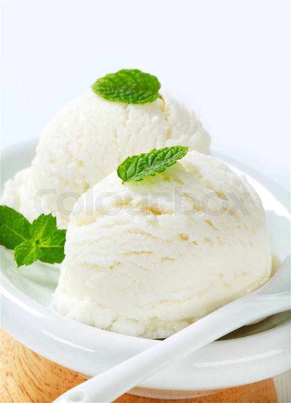 Two scoops of white ice cream (lemon, yogurt or mint flavor), stock photo