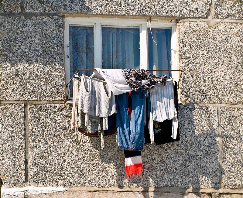 Unusual clean clothing dry against the home window, stock photo