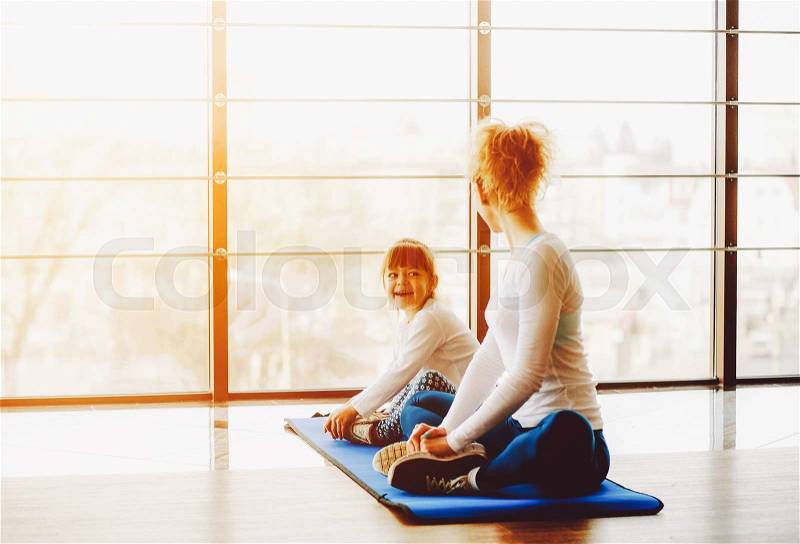 Two girls of different ages makeing yoga, stock photo