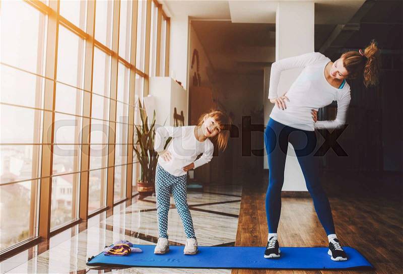 Two girls of different ages makeing yoga, stock photo