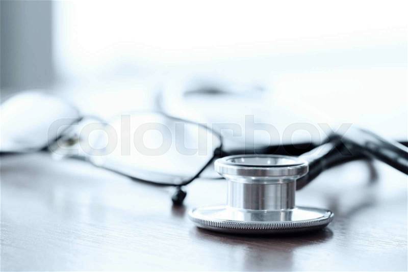 Stethoscope with digital tablet computer on wooden table and background , stock photo