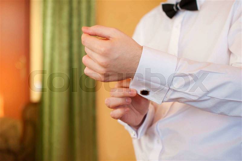 Man wears white shirt and cufflinks, stock photo