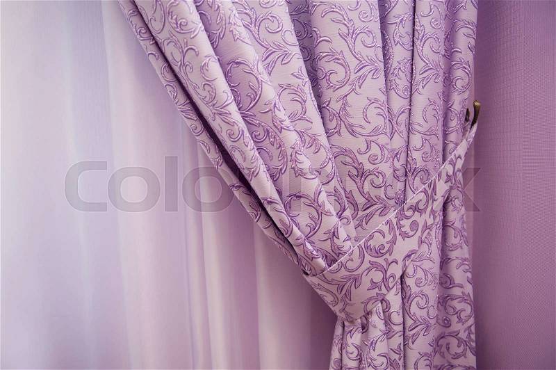 Balcony window with purple curtains, stock photo