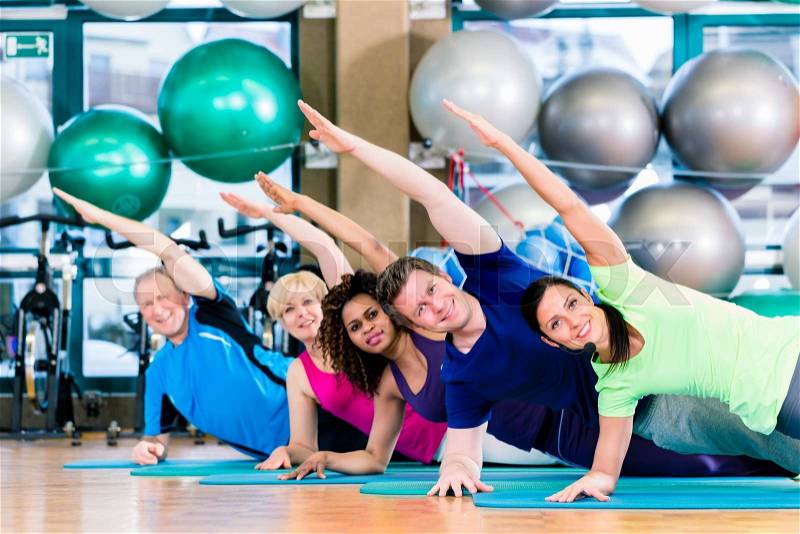 Gymnastic group in gym exercising and training, diversity people, old, young, black and white, stock photo