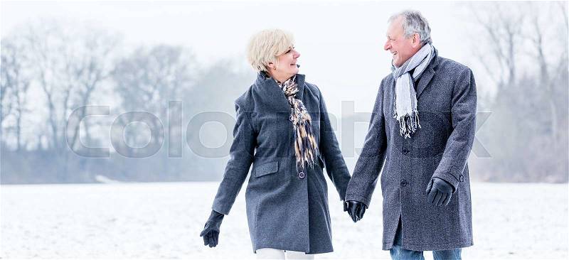 Senior couple having walk in winter, stock photo