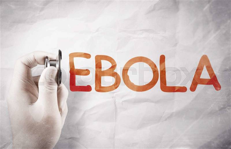 Scientist hand holding stethoscope drawing word ebola on crumpled paper, stock photo