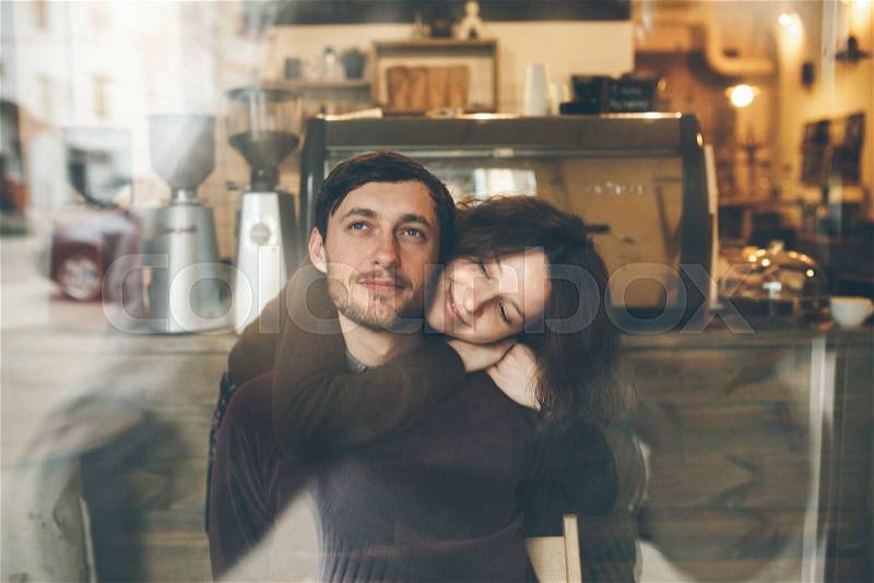 Vintage couple hugs and laughing .Coffee shop. instagram toned, stock photo