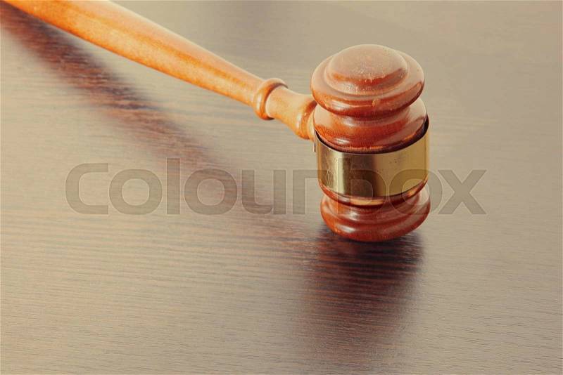 Judge gavel taken closeup on wooden table , stock photo