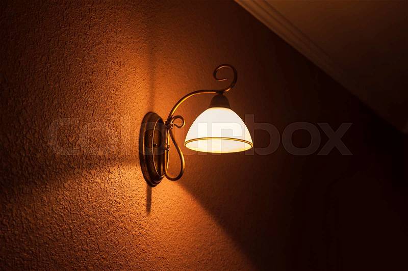 Lighted classic lamp on the wall , stock photo