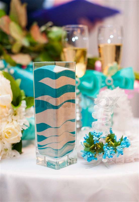 The container and aftermath from the unity sand ceremony performed. Colorful sand using blue, aqua, and white colors. , stock photo