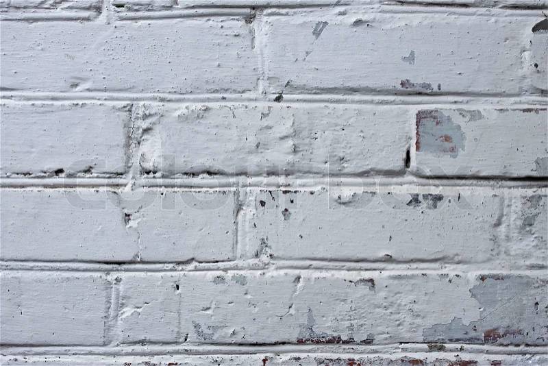 Fragment of old brick walls covered with many layers of paint and lime, stock photo