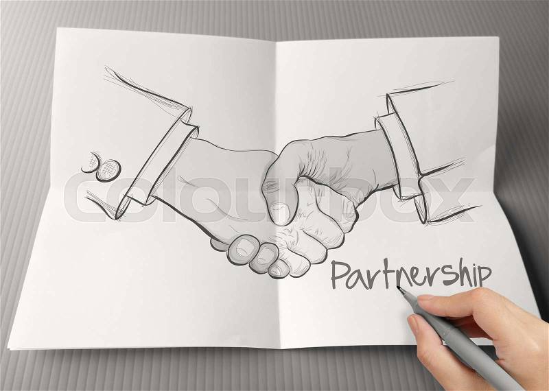 Hand drawn handshake sign on crumpled paper as partnership business concept, stock photo