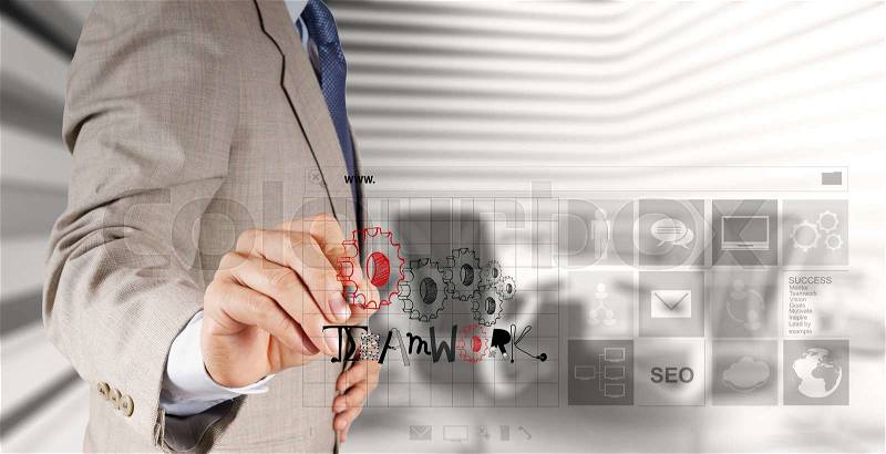 Businessman hand drawing design graphic word TEAMWORK as concept , stock photo