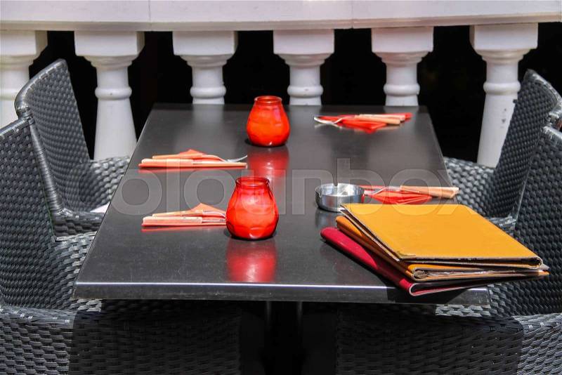 Menu and red candles on black table of street cafe. Zandvoort, the Netherlands, stock photo
