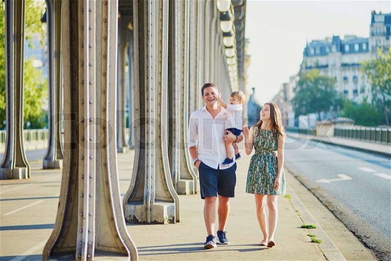 Happy family of three enjoying their vacation in Paris, France, stock photo