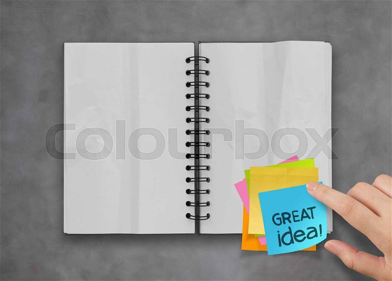 Great idea word sticky notes with open blank note book on desk top texture, stock photo