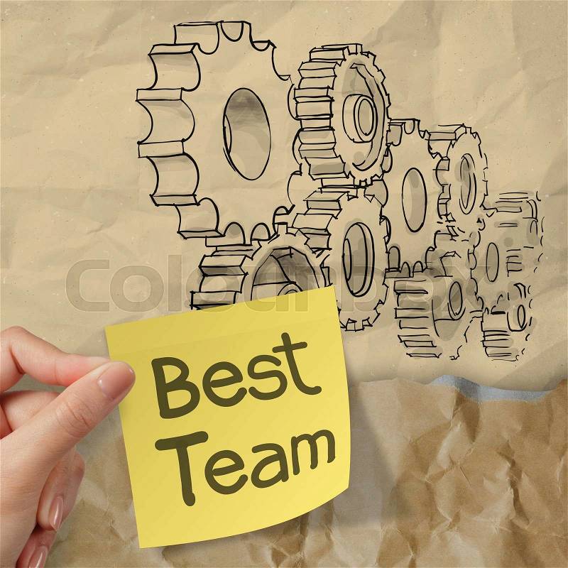 Hand hold sticky note with best team word with gear to success concept on crumpled paper as concept, stock photo