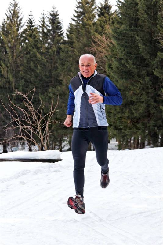 Seniors country skiers in winter on snow while jogging, stock photo