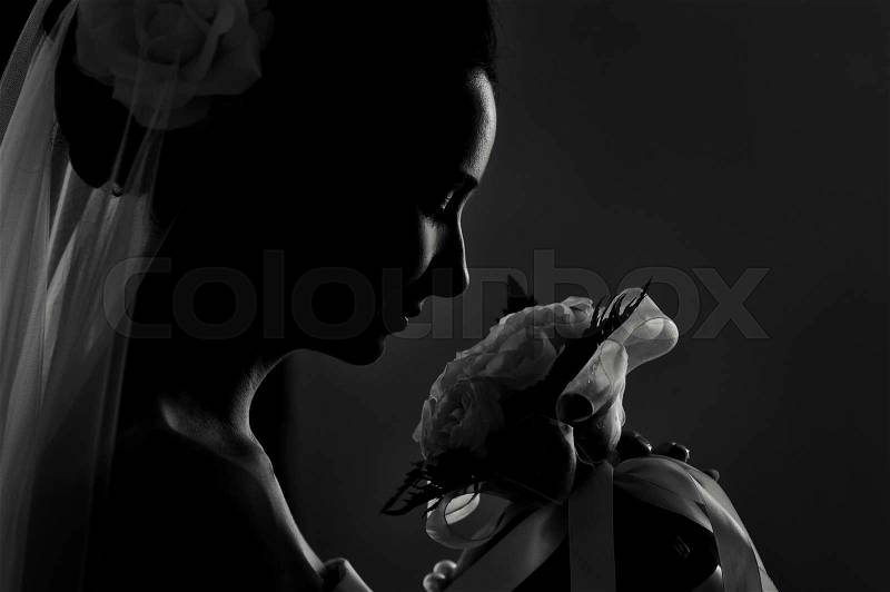 Silhouette of a bride\'s wedding bouquet sniffing, stock photo