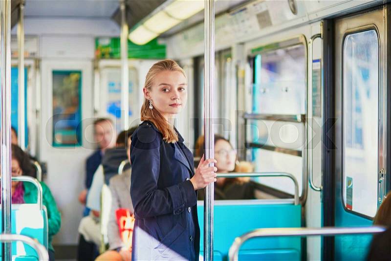 Beautiful young woman travelling in a train of Parisian underground, stock photo