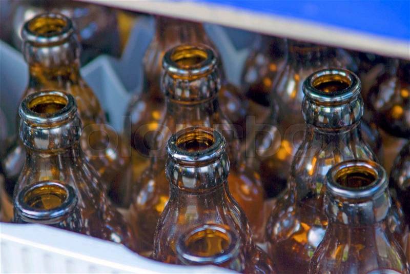 Empty beer bottles in a crate, stock photo