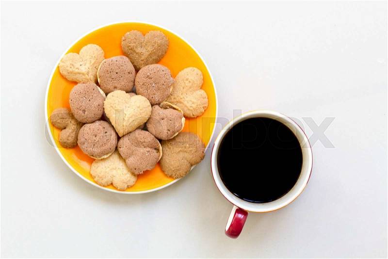 Chocolate cookies and butter cookies on white dish with black coffee, stock photo