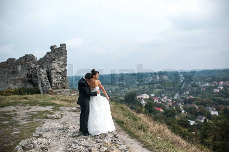Wedding couple posing for the camera on the hump, stock photo