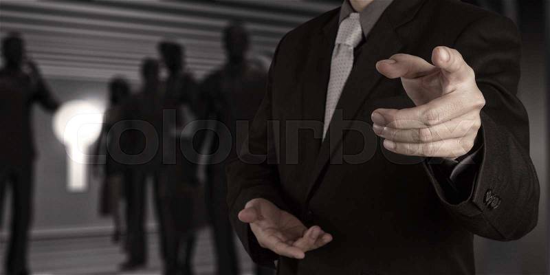 Businessman hand pressing an imaginary button on virtual screen, stock photo