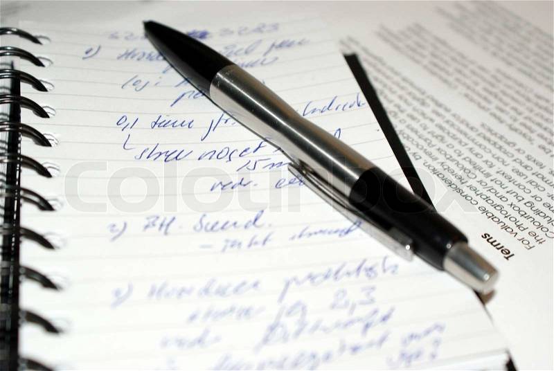 Taking notes on paper notebook, stock photo